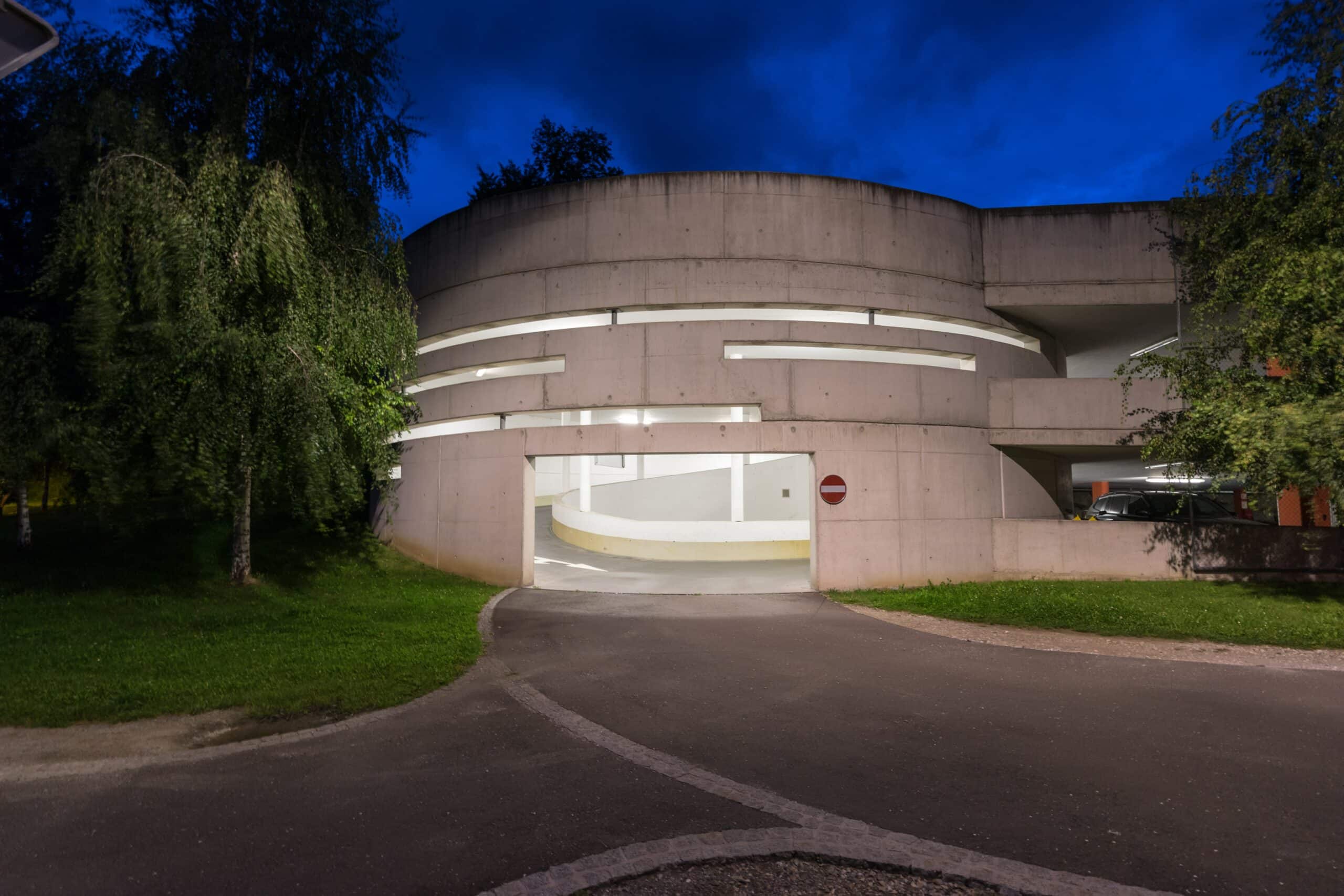 photography of gray concrete building at night time